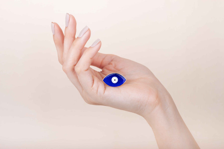 Hand painted enamel and gold plated cobalt blue eye ring worn on finger