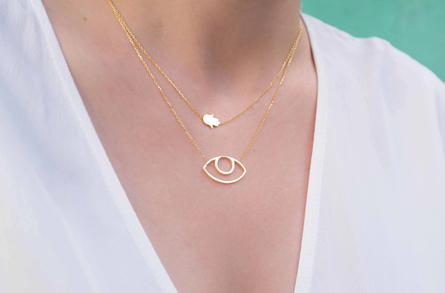 Gold plated abstract eye necklace worn on neck